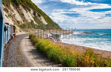Scenic train ride along Pacific ocean coast in Canterbury regoin, South Island of New Zealand