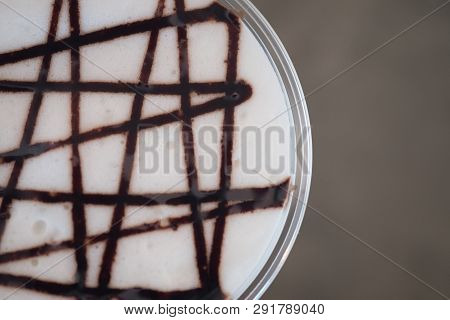 Iced Coffee With Chocolate Sauce On Milk Froth