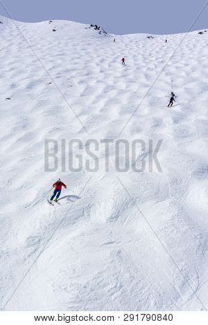 Skiers Descending The Steep Mogul Ski Hill Slope At A Mountain In Lake Louise In The Canadian Rockie