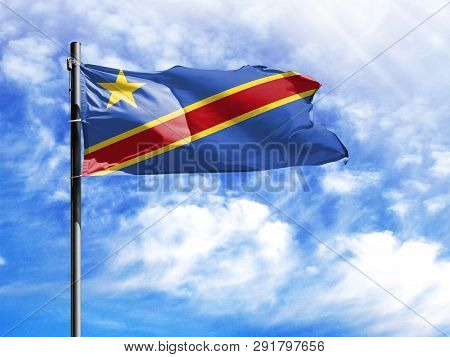 National Flag Of Congo Democratic On A Flagpole In Front Of Blue Sky.