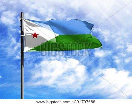 National Flag Of Djibouti On A Flagpole In Front Of Blue Sky.
