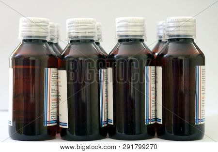 Bunch Of Amber Colored Medicine Pet Bottles With Transparent 10 Ml Dosage Cap