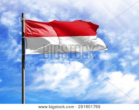 National Flag Of Monaco On A Flagpole In Front Of Blue Sky.