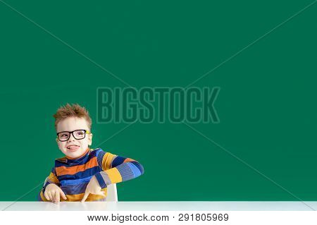The Gamine Boy In Glasses Shows Tongue. Copy Space.