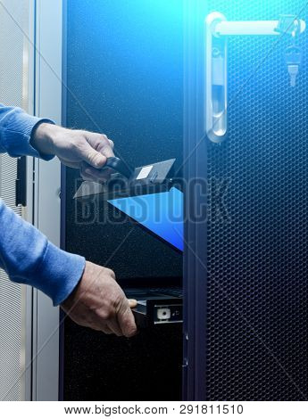 Hands Men Folded System Monitor Server In Modern Data Center. Blue Light