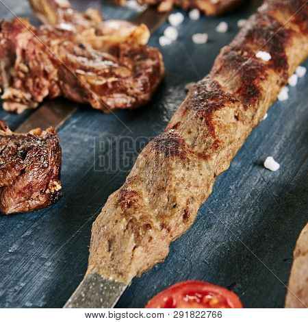 Set of Restaurant Barbecue Menu with Various Lyulya Kebab and Sause Collection on Luxury Black Stone Top View. Lule Kebabs Bbq with Beef, Chicken and Mutton on Skewers Flat Lay