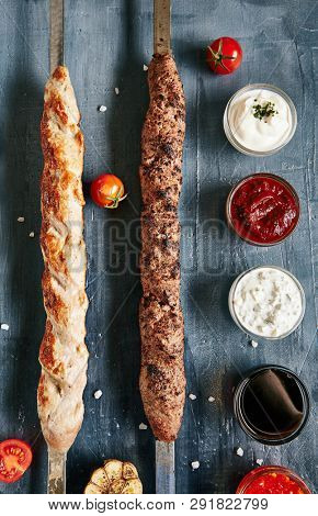 Set of Restaurant Barbecue Menu with Various Lyulya Kebab and Sause Collection on Luxury Black Stone Top View. Lule Kebabs Bbq with Beef, Chicken and Mutton on Skewers Flat Lay