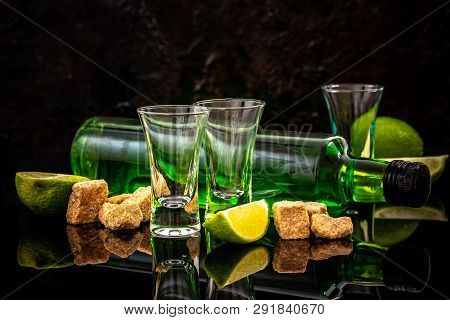 The Concept Of Strong Alcohol. Absinthe With A Sugar Cubes, Lime Slices. Absinthe. Space For Text.