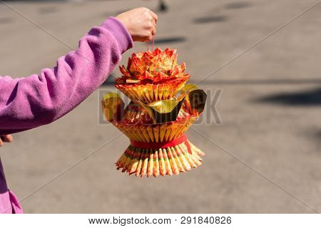 Nantou, Taiwan - FEB 8th, 2019: woman hold a lotus made by joss paper ready for burn at a Baohu Dimu Temple
