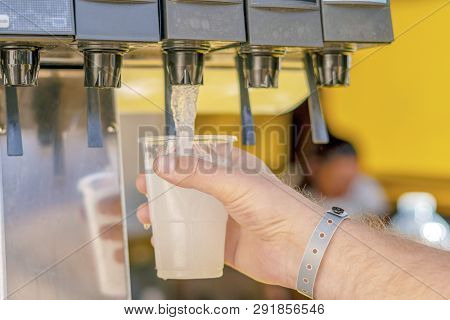 Man Pouring Fresh Drink In Self Service Bar