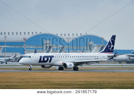 MINSK, BELARUS - JUNE 15, 2018: LOT Polish airlines flight Embraer 195 plane taxi on runway in National Airport Minsk