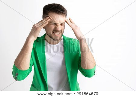 Man Having Headache. Business Man Standing With Pain Isolated On Gray Studio Background. Male Half-l