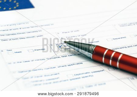 Schengen Visa, Questionnaire. Hand With Pen Completing A Questionary