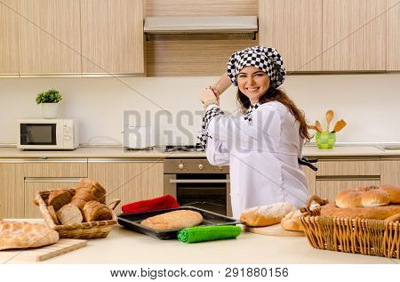 Young female baker working in kitchen