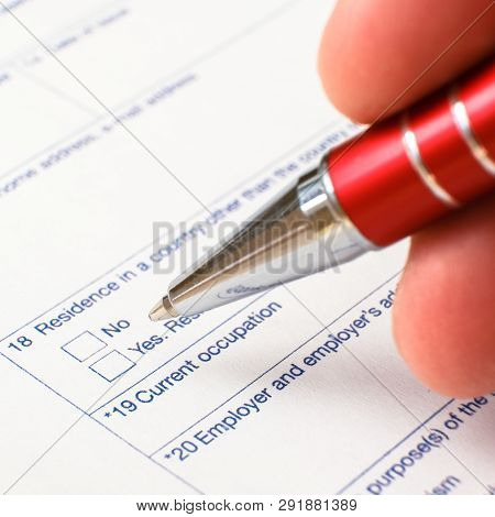 Schengen Visa, Questionnaire. Hand With Pen Completing A Questionary
