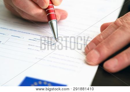 Schengen Visa, Questionnaire. Hand With Pen Completing A Questionary