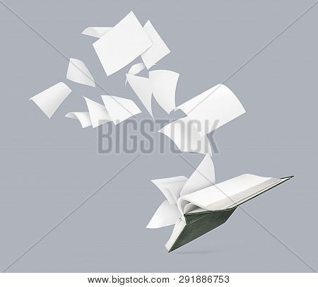 An Empty Book With Flying Pages Isolated On A Gray Background