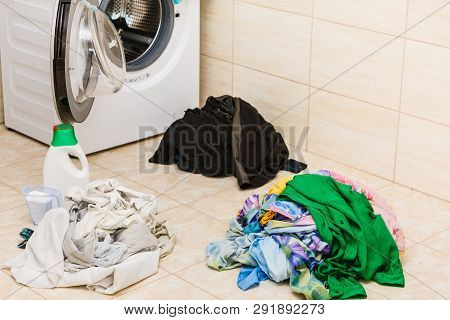 Washing Powder Detergent And Measuring Cup Next To Machine In Bathroom. Household Duties, Clothes La