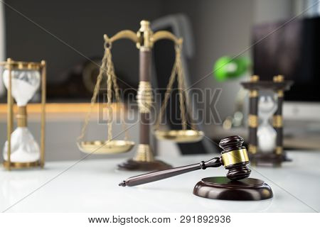 Lawyers Office. Gavel, Scale And Computer On The White Table.