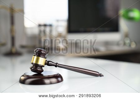 Lawyers Office. Gavel, Scale And Computer On The White Table.