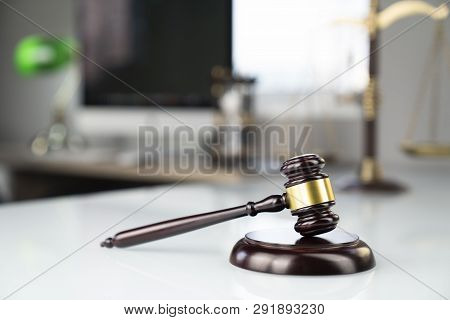 Lawyers Office. Gavel, Scale And Computer On The White Table.