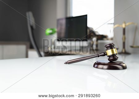 Lawyers Office. Gavel, Scale And Computer On The White Table.