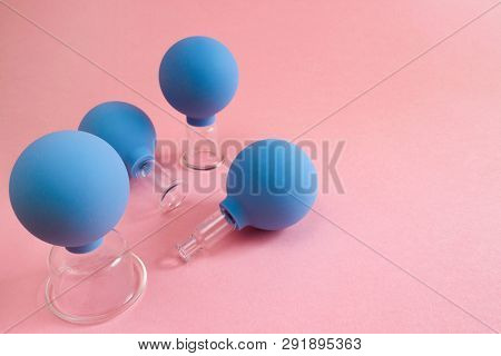 Four Blue Cosmetic Vacuum Jars For Body And Face Massage Of Different Sizes Made Of Glass And Rubber