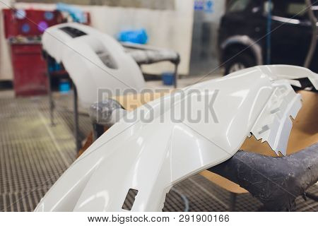 Repair Of The Rear Bumper Of A White Car After An Accident With The Help Of Multi-colored Putty In A