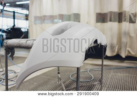 Repair Of The Rear Bumper Of A White Car After An Accident With The Help Of Multi-colored Putty In A
