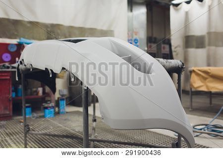 Repair Of The Rear Bumper Of A White Car After An Accident With The Help Of Multi-colored Putty In A