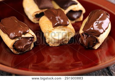 Traditional French Dessert. Eclair With Chocolate Icing. Pastery Concept With Chocolate Eclair