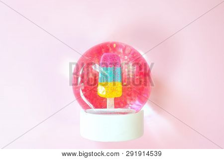 Beautiful Snow Ball With Ice Cream And Glitter Inside On Pastel Pink Background