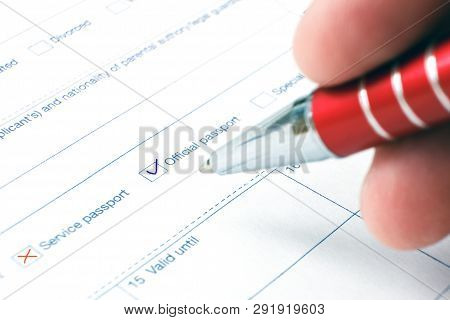 Schengen Visa, Questionnaire. Hand With Pen Completing A Questionary