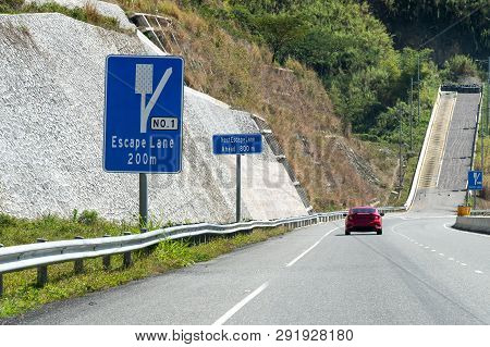 Escape Lane Ahead On Highway Through Mountains On Caribbean Island