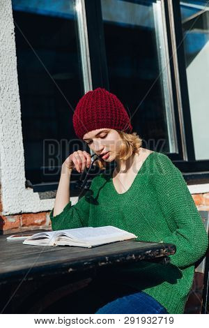 Young Female Sudent Learning In Coffee Shop Outdoor