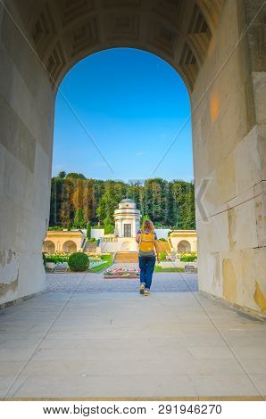 Lviv, Ukraine- August 31, 2018: Lychakiv Cemetery At Sunset. Young Woman Tourist With A Yellow Backp