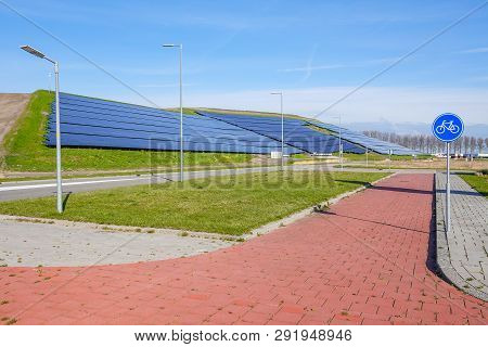 A Hilside Ful Of Solar Panels Providing Clean Electric Power