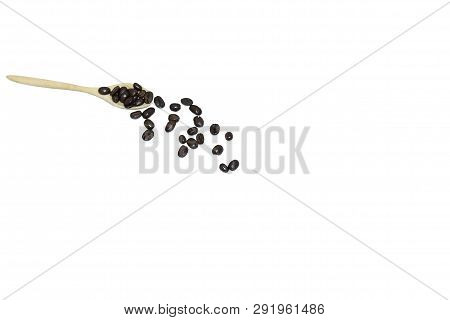 In Selective Focus Many Very Dark Roasted Coffee Beans In A Wooden Coffeecup And On A Floor, White I