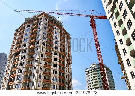 Construction Site Background. Hoisting Crane And New Multi-storey Buildings. I.ndustrial Background.