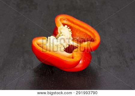 One Half Of Bulgarian Red Bell Pepper On Grey Stone