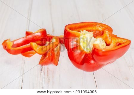 Group Of One Whole Four Slices Of Bulgarian Red Bell Pepper On White Wood