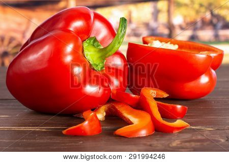 Group Of One Whole One Half Four Slices Of Bulgarian Red Bell Pepper With Cart In Background