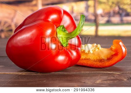Group Of One Whole One Slice Of Bulgarian Red Bell Pepper With Cart In Background