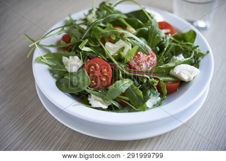 Fresh Salad With Aragula And Tomato In A Plate