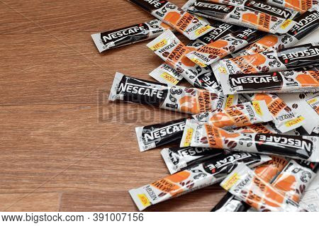 Many Nescafe Caramel Cream Coffee Sticks On Wooden Background. Nescafe Is A Brand Of Coffee Made By 