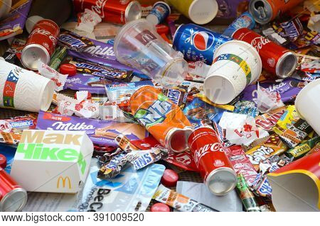 Many Wrappings And Cans From Used Products By Famous Worldwide Brands. Pattern Of Trash Of Various C