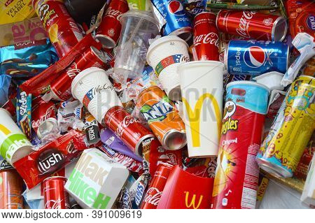 Many Wrappings And Cans From Used Products By Famous Worldwide Brands. Pattern Of Trash Of Various C