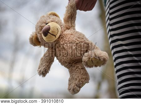 a teddy bear hanging on a black and white outline