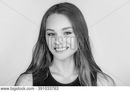 Portrait Of A Cute Blonde Girl Standing On White Background. Close Up Portrait Of Young Cheerful Bea