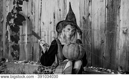 Witch Posing With Pumpkin. Appy Halloween. Happy Gothic Young Woman In Witch Halloween Costume. Hall